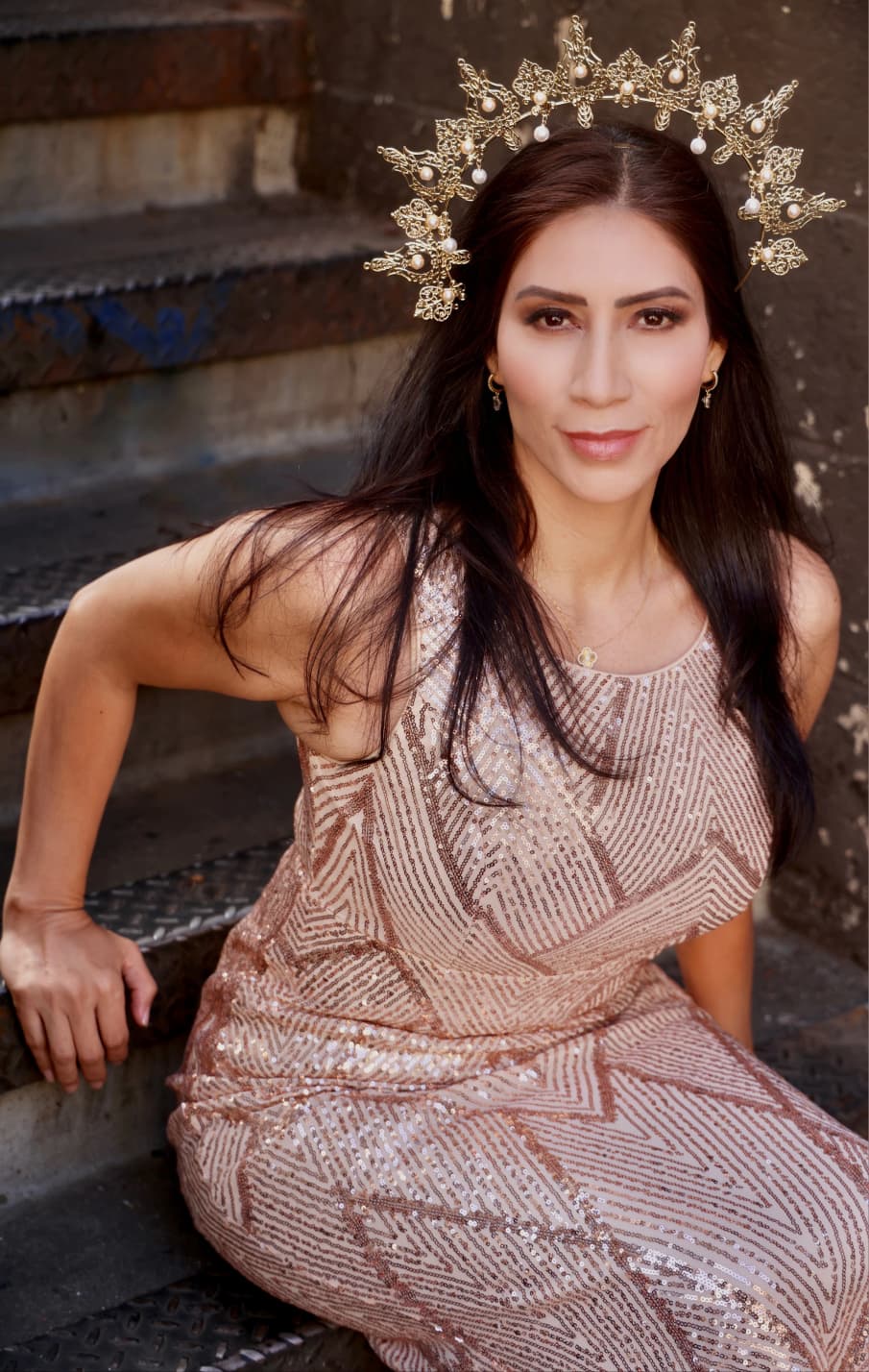 Maria Martinez in a beaded gown and gold headpiece